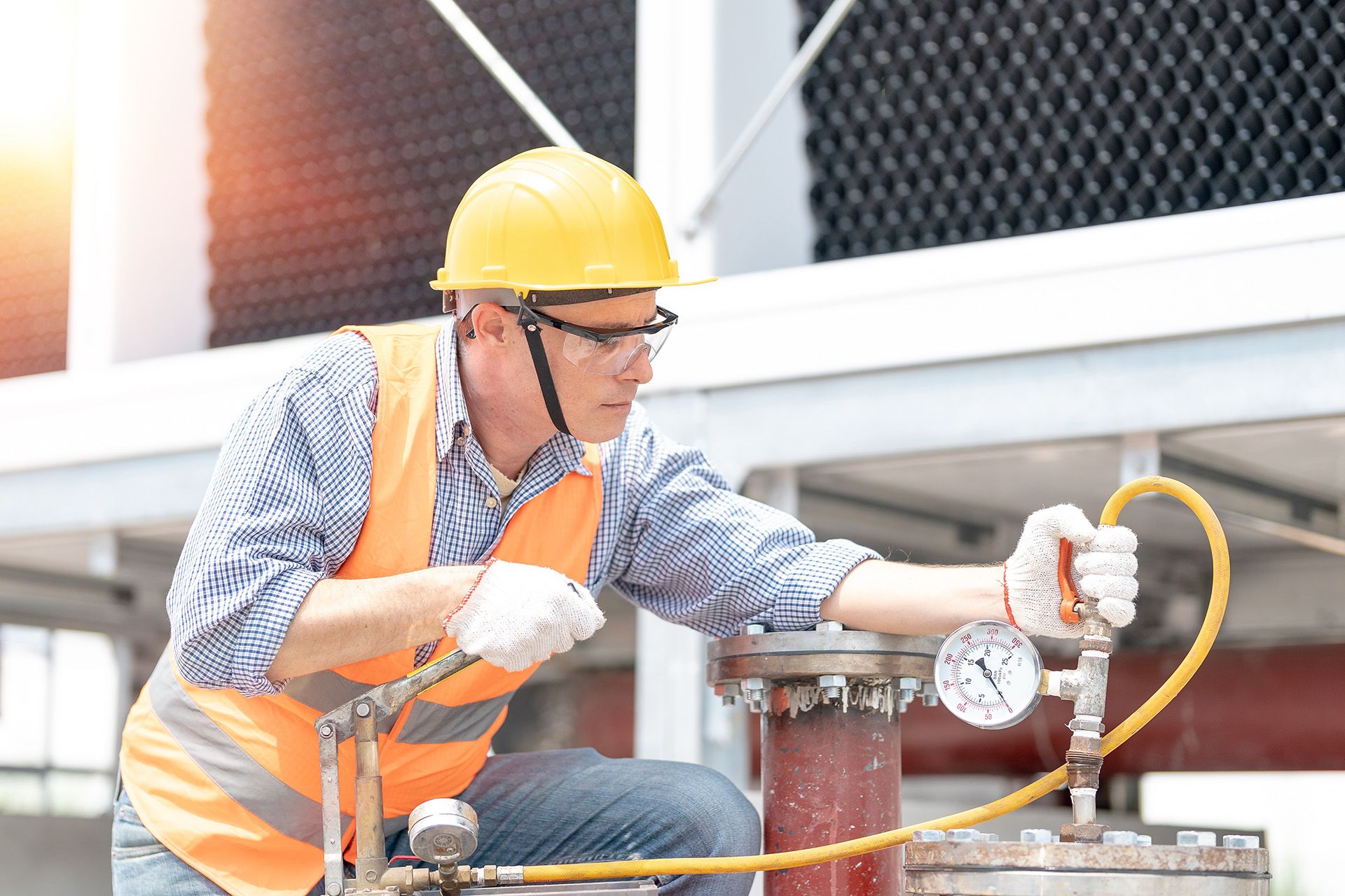 engineer inspecting pressure gauge of heating system